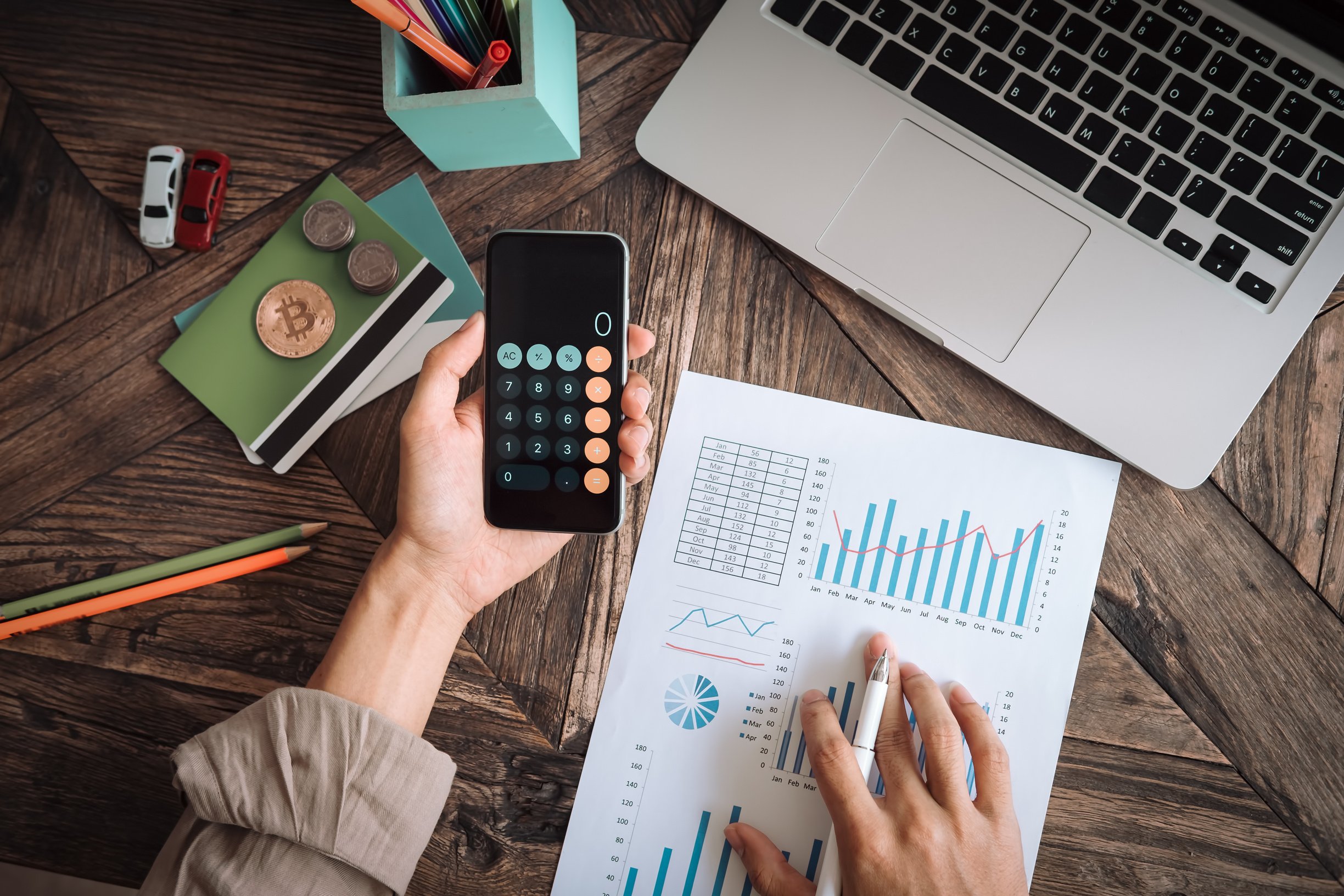 Man Working with Calculator to Calculate Data on Document